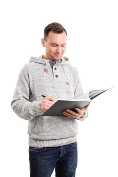 Young man writing in a notebook Stock Photos