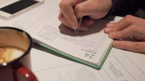 Young man writing in notepad in cafe Stock Footage 58637799