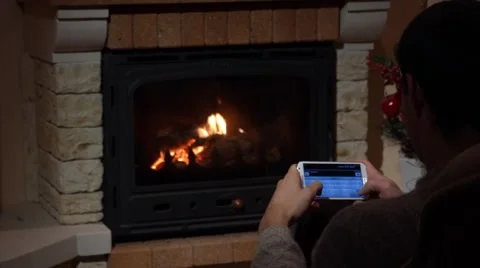 Young Man Is Writing An SMS In Front Of A Fireplace Communication Concept Stock Footage 44015595