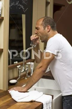 Young man yawning in the bathroom Stock Photos