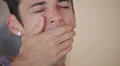 Young man yawning with tears and smiling to the camera HD Footage