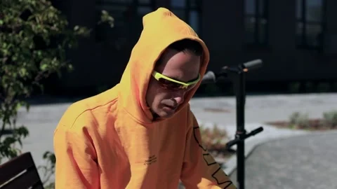 Young man in yellow sunglasses using smart phone mobile traveling by electric sc 스톡 동영상 211816718