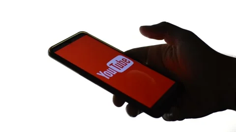 Young man with youtube icon logo on his phone. youtube video network app Stock Footage 196277757