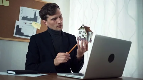 Young manager chatting with customer using laptop computer Stock Footage 79901346