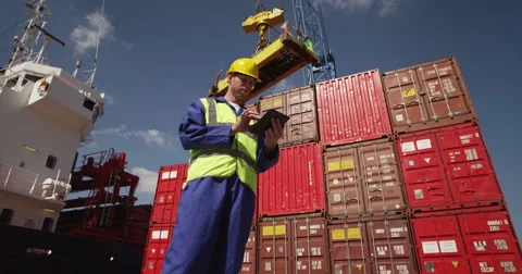 A young manager doing inspection rounds through an industrial harbor. Stock Footage 54931774