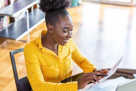 Young manager doing paperwork and reading contract.Business professionals. Bu Stock Photos