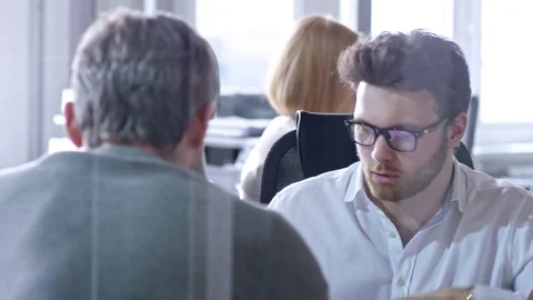 Young Manager Explaining Something to Colleagues Stock Footage 79533619