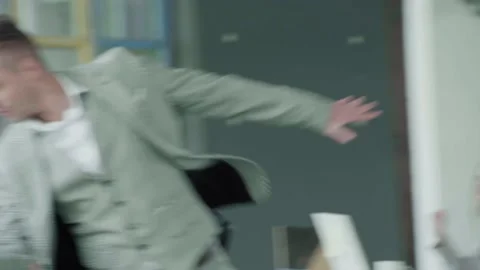 The young manager expressively dances with a glass in the office and throws it Stock Footage 134166102