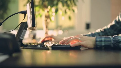 Young manager in the office working on the computer. sunset office Stock Footage 72571787