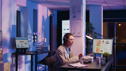 Young manager planning report wearing headphones Stock Footage 233850779