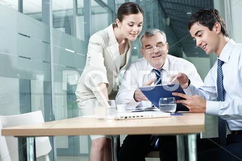Young manager showing plan to his colleagues Stock Photos