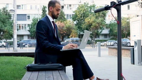 Young manager in suit working on the laptop outdoor in the city Stock Footage 114751655