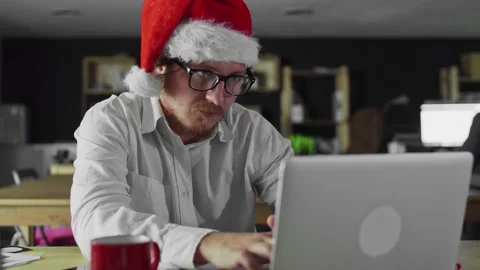 Young manager is working and speaking on smartphone in Office on Christmas Video stock 130535011