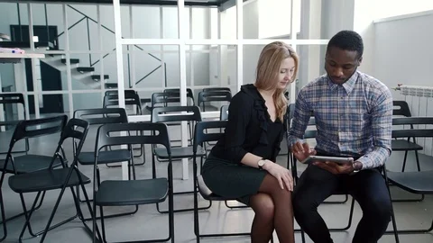 Young managers communicate, using tablet in large company. Stock Footage 82349109