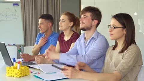 Young managers engaged in a lively discussion at the office Stock Footage 311951665