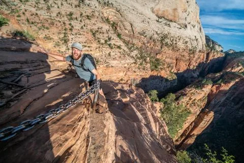 Young mans epic summit to top of Angels Landing trail - Zion National Park Stock Photos