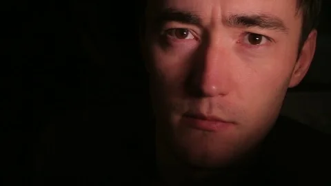 Young man's face in the dark. Closeup shot. Stock Footage 82726062