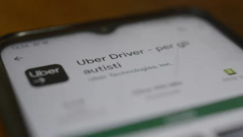 Young man's hand download uber driver app on his smartphone Stock Footage 200821992