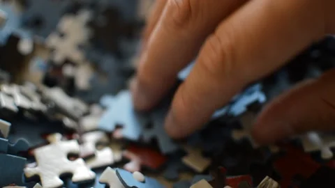 Young man's hand looking for the solution of the puzzle. puzzle background. Stock Footage 209485924