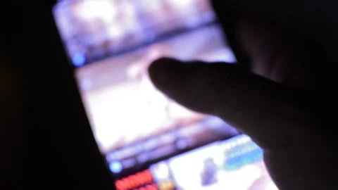 Young man's hand scrolling PornHub XXX erotic website on his phone Stock Footage 201658160