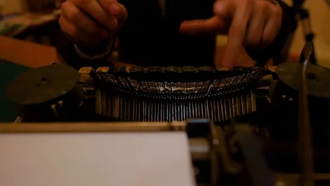 The young man's hands are printed on an old typewriter Stock Footage 93663876