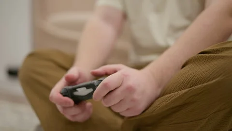 Young man's hands playing video game with console controller Stock Footage 340925796