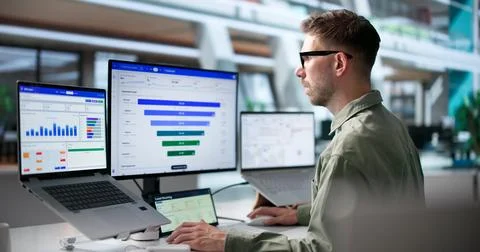 Young Marketing Manager Studies Sales Funnel Data Using Laptop For Customer A Stock Photos