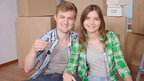 Young married couple with boxes and holding flat keys Stock Footage 78538939
