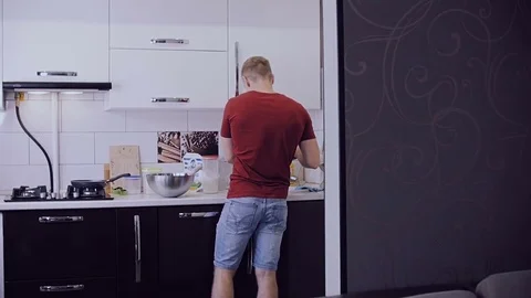Young married couple preparing breakfast in their kitchen. Stock Footage 77523417