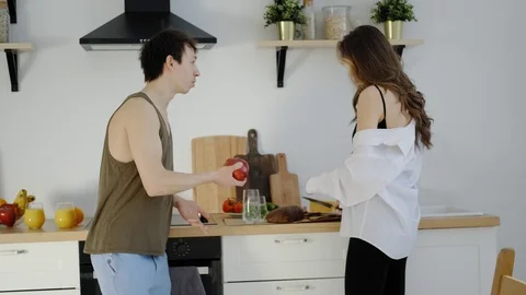 Young married couple preparing breakfast in the sunny kitchen. Stock-Footage 106835744