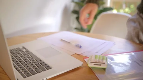 Young married man doing budgeting on laptop and calculator Stock Footage 126560805