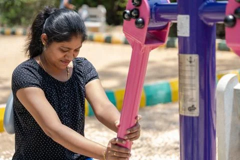 Young Married Women's Exercise Routine in the Children's Park Stock Photos