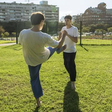 Young martial artists practicing a precise kick Stock Photos