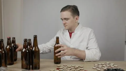 Young master technologist brews beer at home Stock Photos