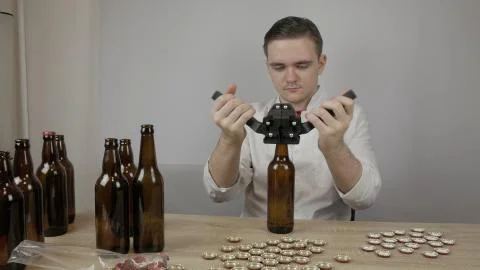 Young master technologist brews beer at home Stock Photos