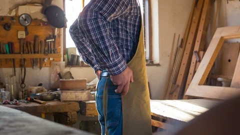 A young master tightens an apron Stock Footage 89774503