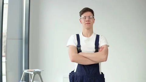 Young master in work uniform and protective glasses looking at the camera Video stock 147040538