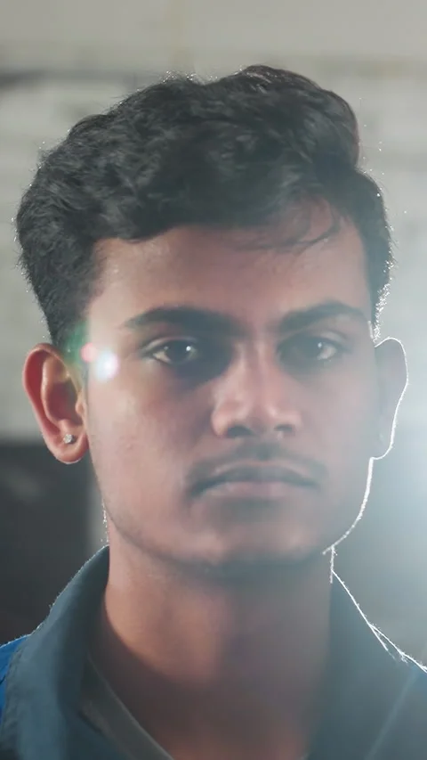 Young Mechanic in Industrial Workshop with Dramatic Lighting Effect 스톡 동영상 318242749