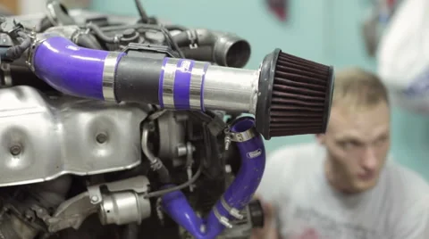 Young mechanic inspect the car engine Stock Footage 68012366