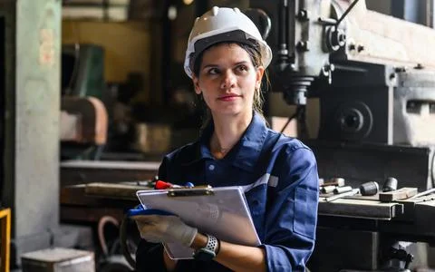 Young mechanical engineer repairing engine machine at repair shop Stock Photos