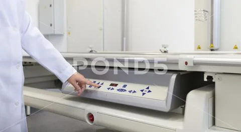 Young medical specialist starting high tech machine Stock Photos