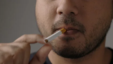 Young men are going to smoke He put a cigarette in his mouth. Stock Footage 152765989