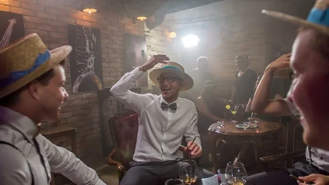 Young men are lifting their straw hats up in the air Stock Footage 112190885