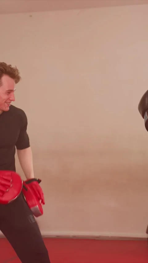 Young Men Boxing Practice with Punches and Focus Mitts in Indoor Gym showing Stock Footage 345547078