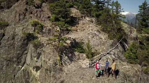 Young Men On Cliff Edge Taking In Beautiful Mountains And Scenery Video stock 78657331