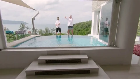 Young Men Dance on Edge of Luxury Infinity Pool on Phuket Thailand Vacation Video stock 85075322
