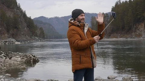 Young men does selfie outside, shivers from cold and having online chat with his 스톡 동영상 99899962