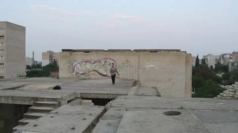 Young men doing a freerunning jumping and flipping stunt. Stock Footage 67316030