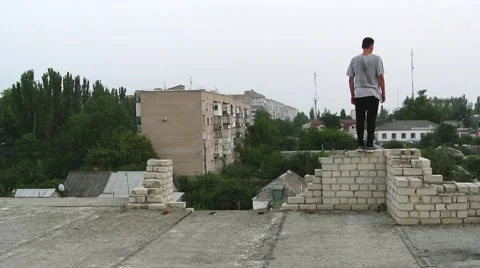 Young men doing a freerunning jumping and flipping stunt. Stock Footage 67316185