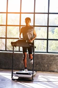 Young men exercise on an automatic treadmill Stock Photos